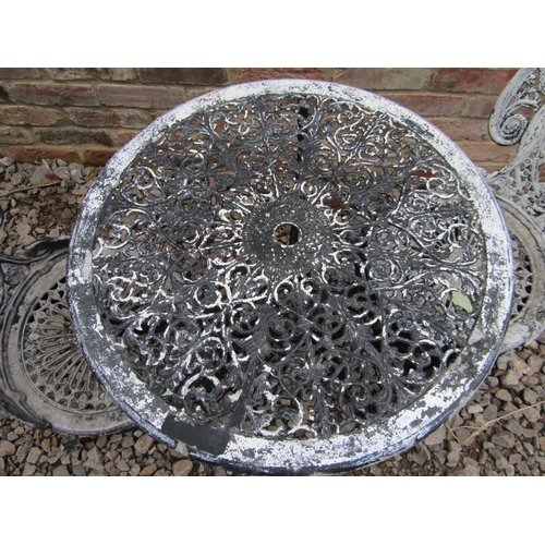 1019 - A painted and weathered cast aluminium garden terrace table of circular form with decorative pierced... 