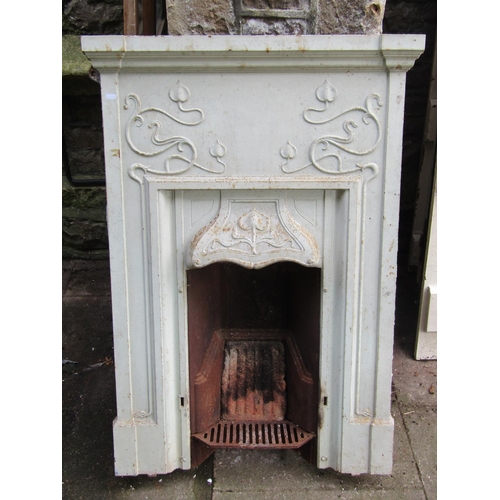 1027 - An Art Nouveau/crafts painted cast iron fireplace/insert, with scrolling organic detail, 94 cm wide ... 