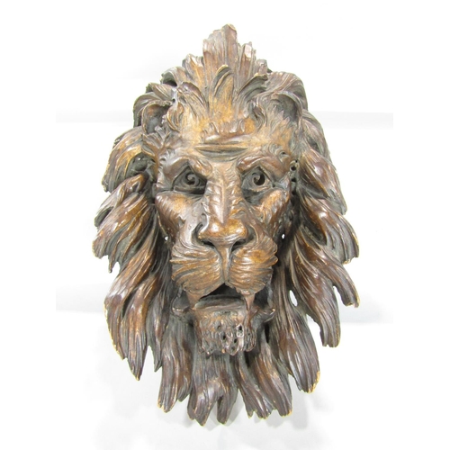 651 - A 19th century carved wooden mask of a lion’s head and mane 40cm x 30cm approx