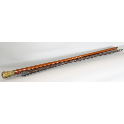 654 - A malacca cane with a gilded scrolled pommel 100cm and a natural wood cane with a silver pommel 90cm... 