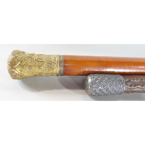 654 - A malacca cane with a gilded scrolled pommel 100cm and a natural wood cane with a silver pommel 90cm... 