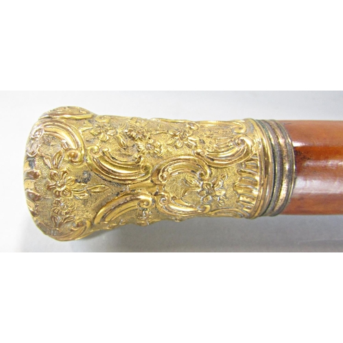 654 - A malacca cane with a gilded scrolled pommel 100cm and a natural wood cane with a silver pommel 90cm... 