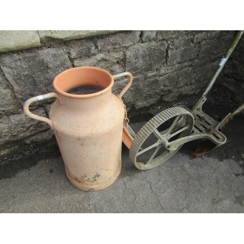 1014 - A vintage French aluminium milk churn with fixed loop handles (complete with lid) but later painted,... 