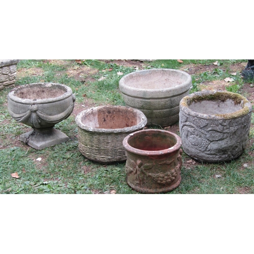 1034 - Four weathered cast composition stone circular garden planters of varying design, one in the form of... 