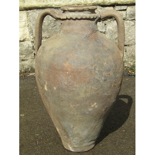 1084 - An old terracotta amphora with moulded neck and loop handles, 55 cm high