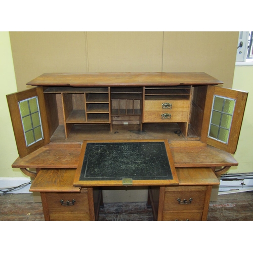 1611 - An arts and crafts oak writing desk - Stone's Patent, the lower section fitted with six drawers and ... 