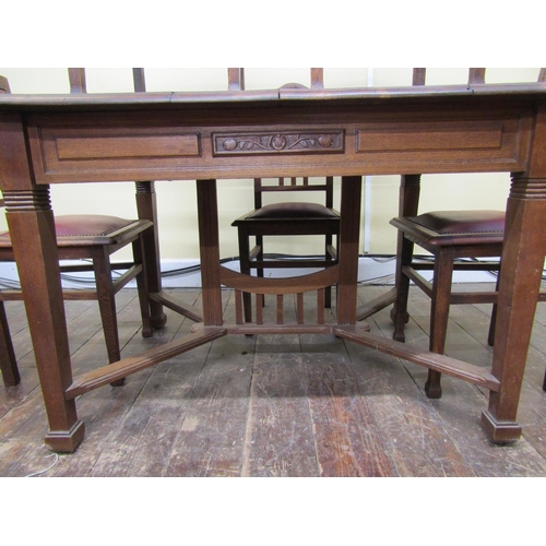 1620 - An arts and crafts oak dining table raised on square cut and tapering supports united by moulded and... 