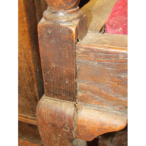 1553 - A Georgian oak settle on pad forelegs with scrolled arms, the back enclosing five arched and fielded... 