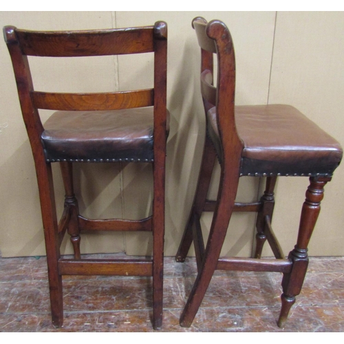 1574 - A pair of 19th century shop or workshop chairs with bar backs and hide upholstered seats on turned s... 