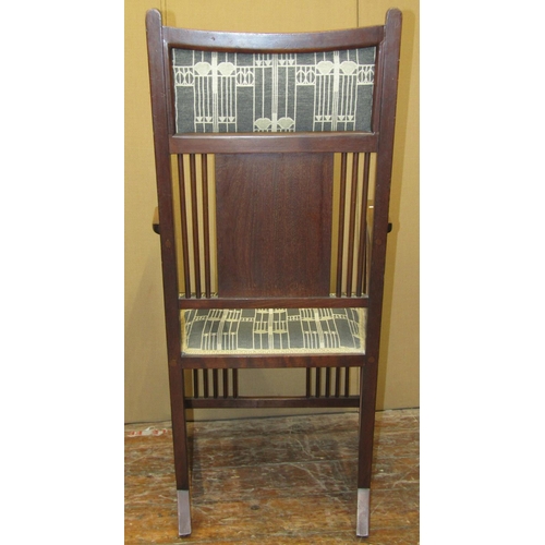 1626 - An arts and crafts elbow chair in mahogany with stick back, sides and low rails, with upholstered se... 