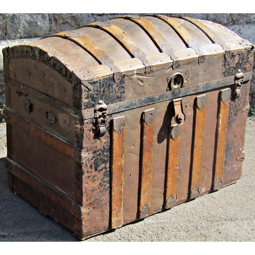 1261 - A late 19th century tin lathe overlay travelling trunk with domed lid,