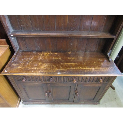 1278 - A good quality Old English style oak dresser, the base enclosed by three rectangular moulded panelle... 