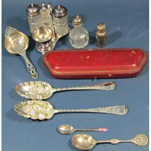 227 - A silver tea strainer, scent bottle, two berry spoons, four piece condiment set, two christening for... 