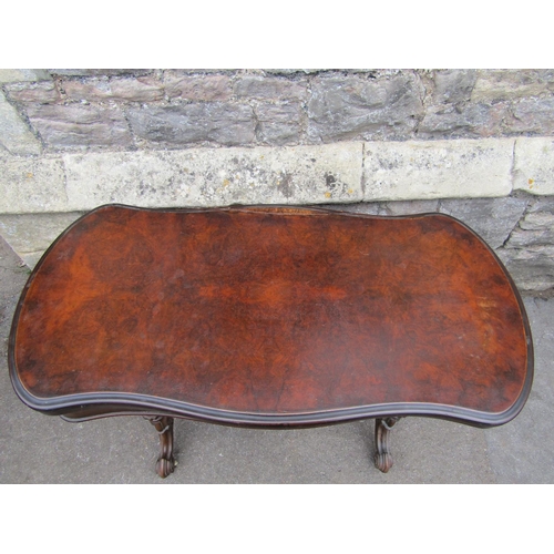 1295 - A Victorian walnut and figured walnut veneered fold over top card table with serpentine moulded outl... 