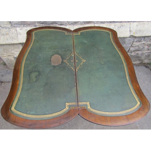 1295 - A Victorian walnut and figured walnut veneered fold over top card table with serpentine moulded outl... 