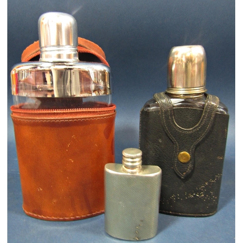 168 - A brown leather clad hip flask with a silver  plated top and toddy cup, another similar with a black... 