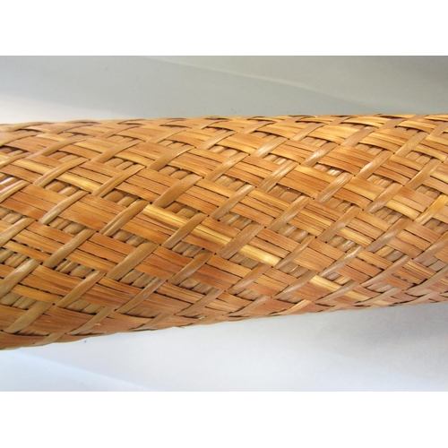 695 - A South East Asian split bamboo storage tube with a loop handle, 180cm long approx