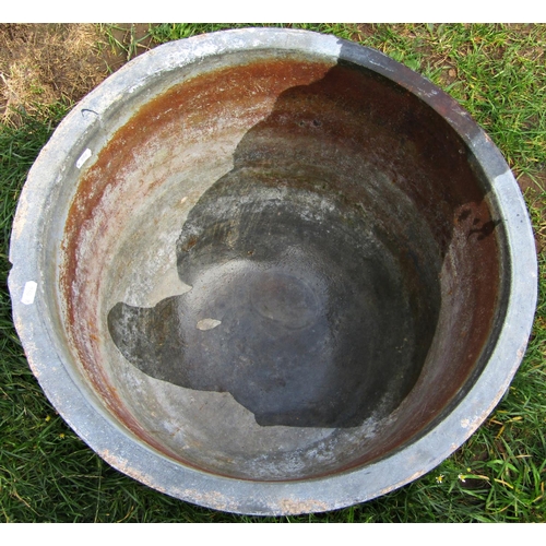 1049 - An old cast iron cauldron with flared rim, 55 cm diameter (af)