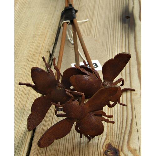 1083 - Three small ornamental steel garden border stakes with floating bee finials, 74cm high