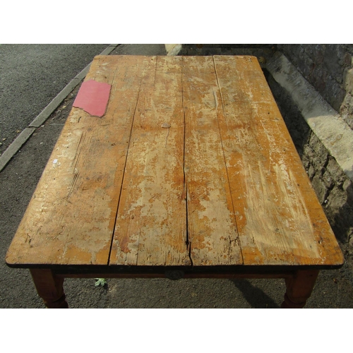 1217 - A Victorian partially stripped pine farmhouse kitchen table of rectangular form with boarded top ove... 