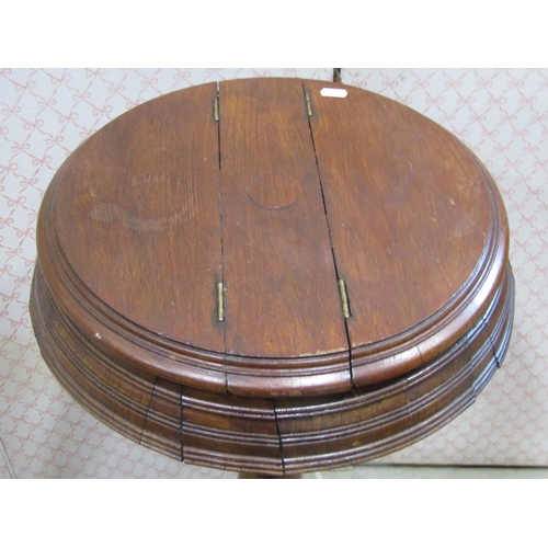 1225 - A late Victorian walnut shaving stand, the circular top enclosing two hinged box compartments raised... 