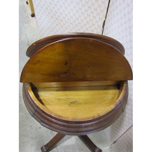 1225 - A late Victorian walnut shaving stand, the circular top enclosing two hinged box compartments raised... 