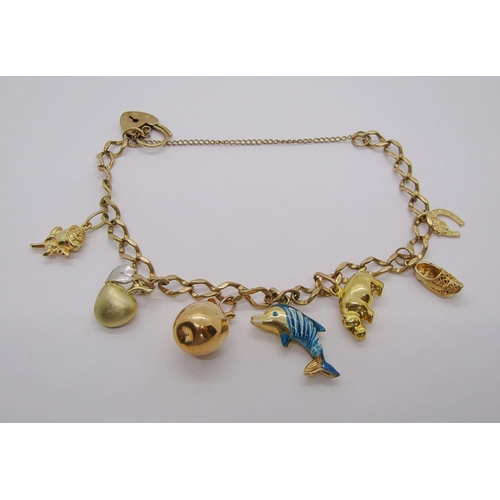 231 - 9ct curb link charm bracelet with heart padlock clasp, hung with seven novelty charms to include an ... 