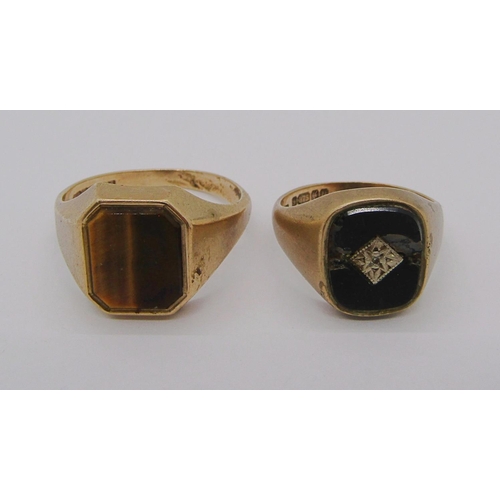 244 - Two 9ct rings; a tigers eye example, size X and an onyx example, size N/O (onyx af), 10.6g total