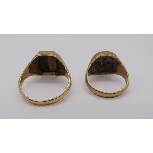 244 - Two 9ct rings; a tigers eye example, size X and an onyx example, size N/O (onyx af), 10.6g total