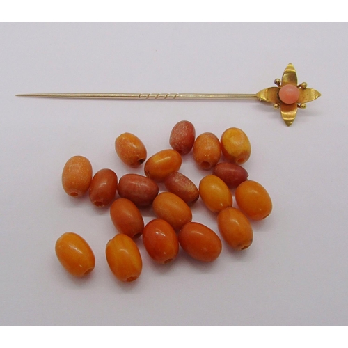 266 - Yellow metal floral stick pin set with coral, 3.7g, together with a quantity of loose amber coloured... 