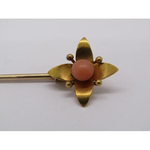 266 - Yellow metal floral stick pin set with coral, 3.7g, together with a quantity of loose amber coloured... 