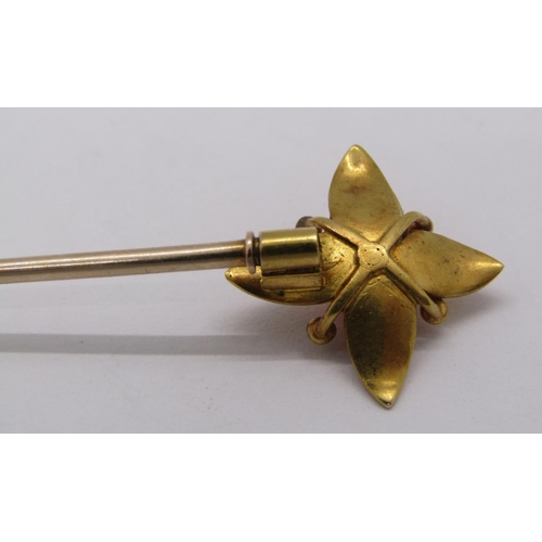 266 - Yellow metal floral stick pin set with coral, 3.7g, together with a quantity of loose amber coloured... 