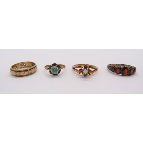 269 - Four gem set rings comprising a 9ct opal and ruby example, a further 9ct example, yellow metal claw ... 