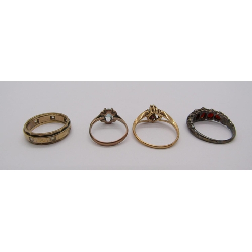 269 - Four gem set rings comprising a 9ct opal and ruby example, a further 9ct example, yellow metal claw ... 