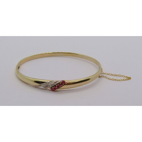 288 - 9ct hinged bangle set with graduated rubies and diamonds, 6.9g