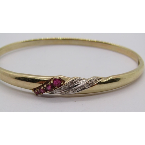 288 - 9ct hinged bangle set with graduated rubies and diamonds, 6.9g