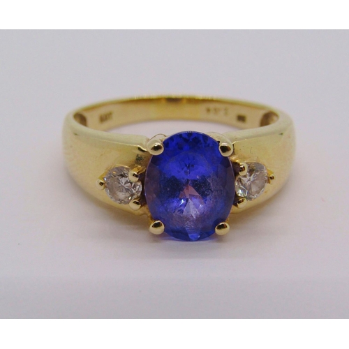 298 - 14ct tanzanite and diamond three stone dress ring, size S, stamped 'HOT' to interior, 4g, with accom... 