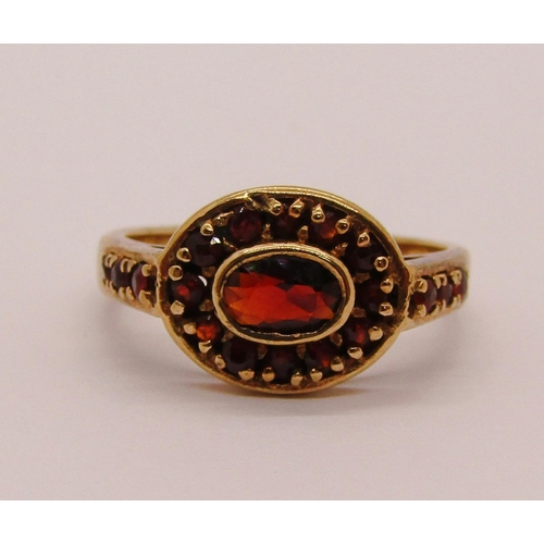 303 - Group of 9ct jewellery comprising a twist ring, size L/M, further garnet cluster ring, size O and a ... 