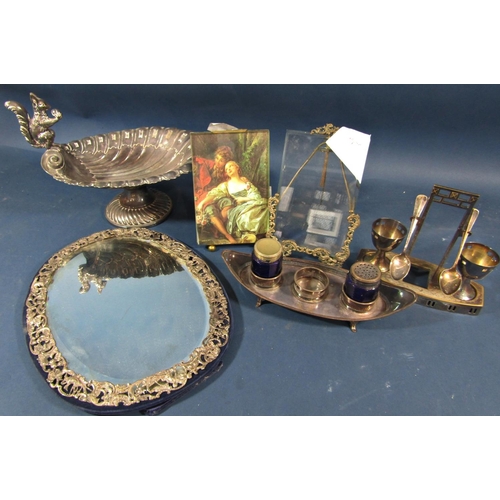 161 - An early 20th century silver metal oval toilet mirror with cherub and bird decoration, a scalloped s... 