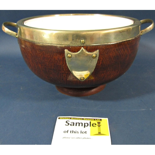 174 - An Edwardian oak fruit bowl with china liner, and four similar oak biscuit barrels.