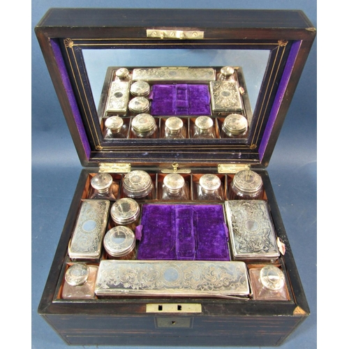 175 - A mid Victorian period coromandel wood and brass banded travelling box, the rising lid fitted with t... 