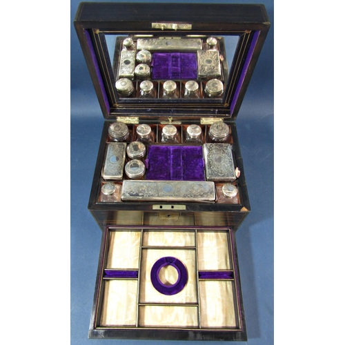 175 - A mid Victorian period coromandel wood and brass banded travelling box, the rising lid fitted with t... 