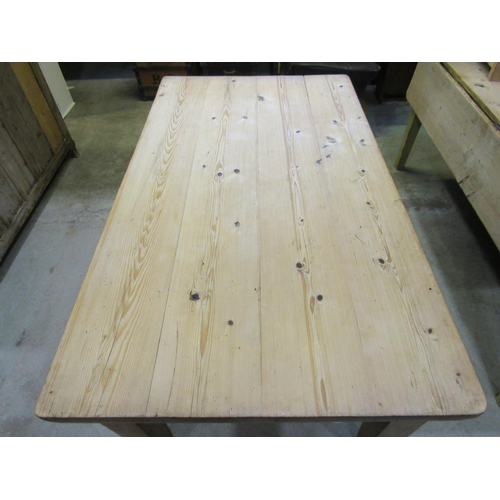 1235 - A 19th century stripped pine farmhouse kitchen table with rectangular top over an end frieze drawer ... 