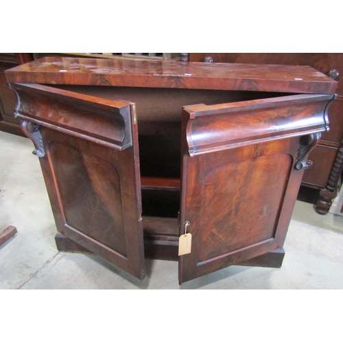 1265 - A Victorian mahogany chiffonier enclosed by a pair of arched panelled doors beneath two frieze drawe... 