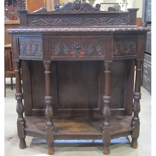 1298 - A Victorian oak breakfront side table, in the Old English style, with scrolling acanthus and further... 