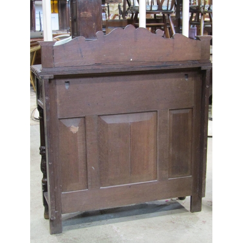 1298 - A Victorian oak breakfront side table, in the Old English style, with scrolling acanthus and further... 