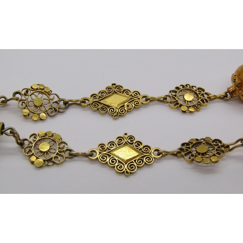 323 - Yellow metal cross pendant necklace with intricate filigree work, 36.5g