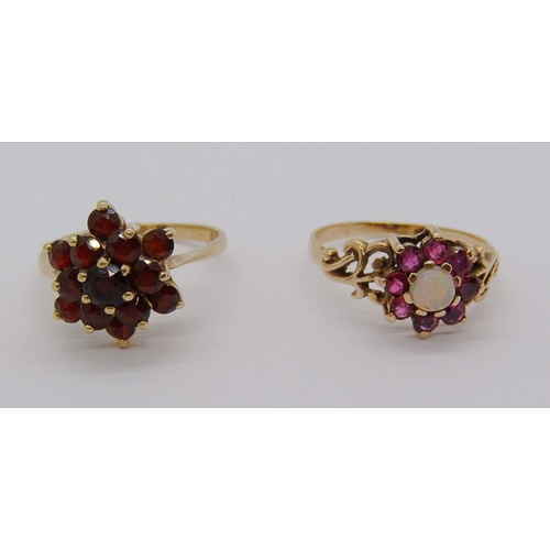 329 - 9ct ruby and garnet cluster ring with scrolled shoulders, together with a further 9ct garnet cluster... 