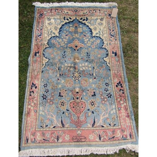 1792 - A mid 20th century Persian Qum rug with a signature with pink flowers on a pale blue ground, 150cm x... 