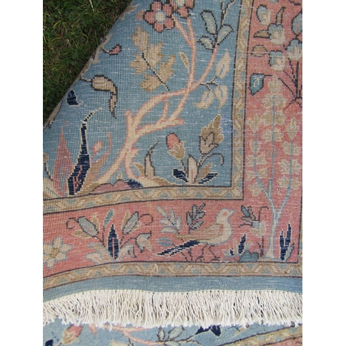 1792 - A mid 20th century Persian Qum rug with a signature with pink flowers on a pale blue ground, 150cm x... 